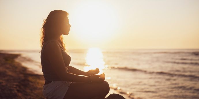 AQC Blog Attracting Abundance 3 Powerful Tips for Busy 6+ Figure Women to Harness the Power of their Thoughts - woman meditating during a sunset