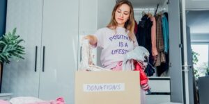 Alpha Queen Collective Blog - Queen Karissa Adkins - The Mental Health Benefits of Spring Cleaning - woman cleaning and organizing her closet for donations etc